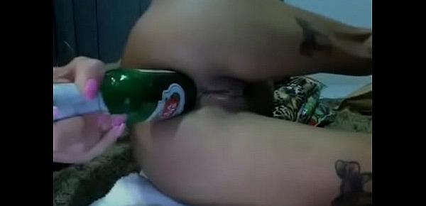  Brunette puts a beer in the ass